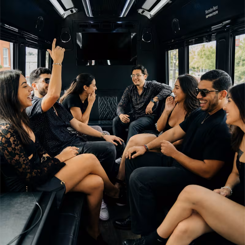 Group boarding a white charter bus for Concert Transportation transportation in Wellington