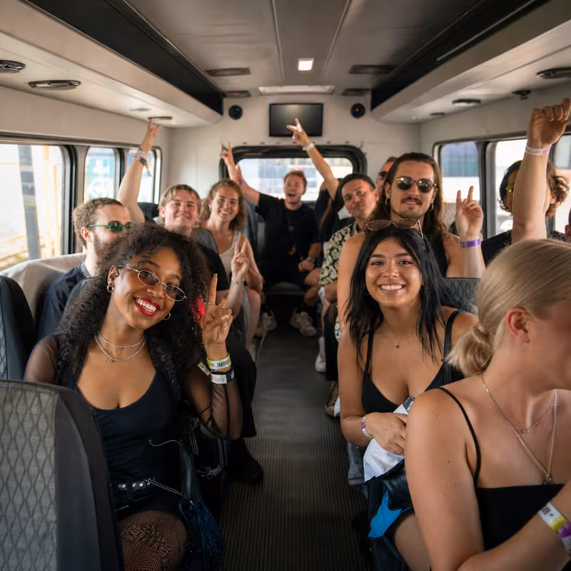 Party bus interior with wraparound leather seating and LED lighting in Wellington