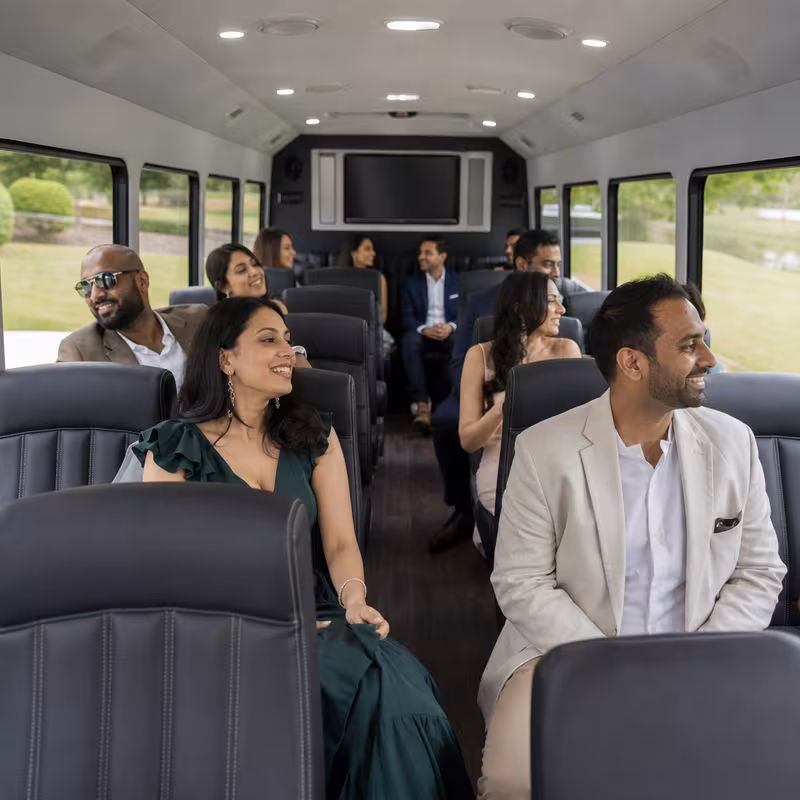 Group boarding a white charter bus for Private Event Transportation transportation in Wellington