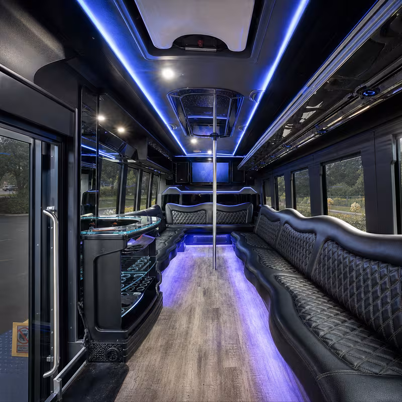 Party bus interior with wraparound leather seating and LED lighting in Wellington