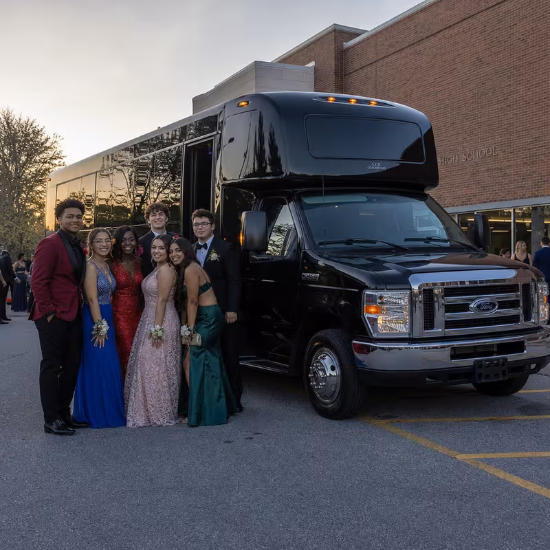 Group boarding a white charter bus for Prom & Homecoming Transportation transportation in Wellington