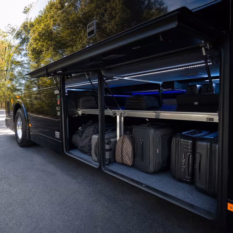 Party bus interior with wraparound leather seating and LED lighting in Wellington