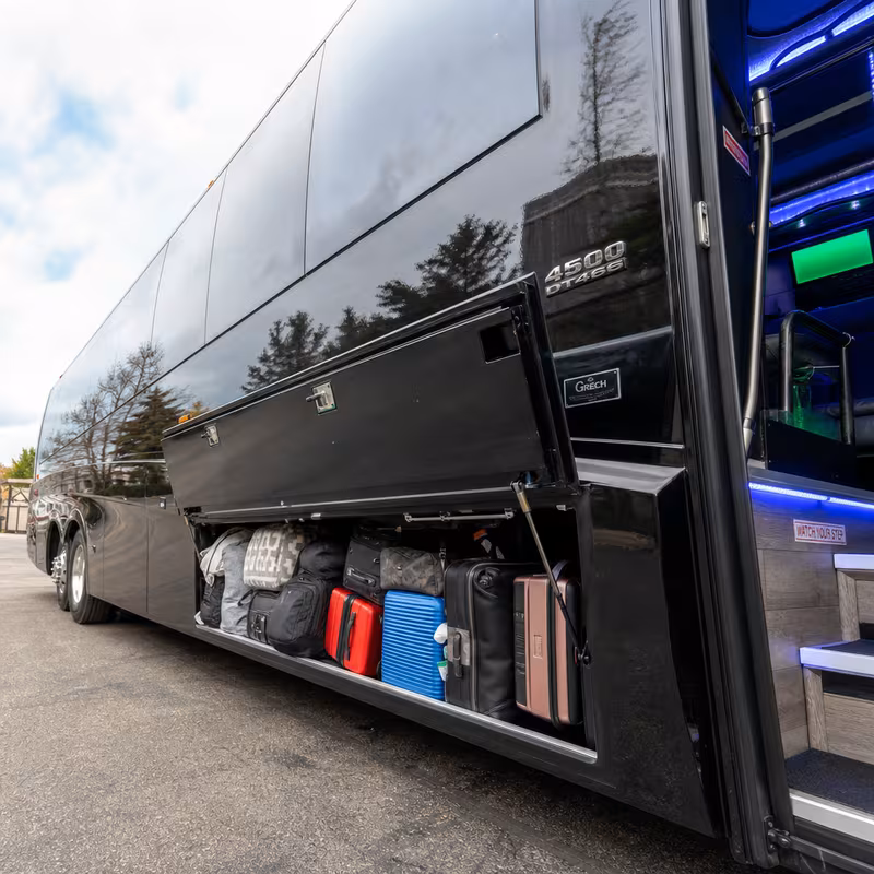 Party bus interior with wraparound leather seating and LED lighting in Wellington