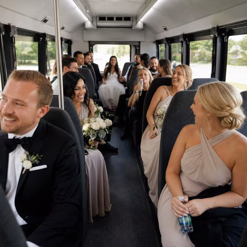 Group boarding a white charter bus for Wedding Transportation transportation in Wellington