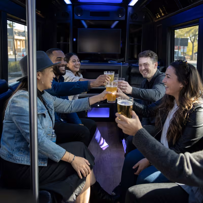Group boarding a white charter bus for Winery & Brewery Tour Transportation transportation in Wellington