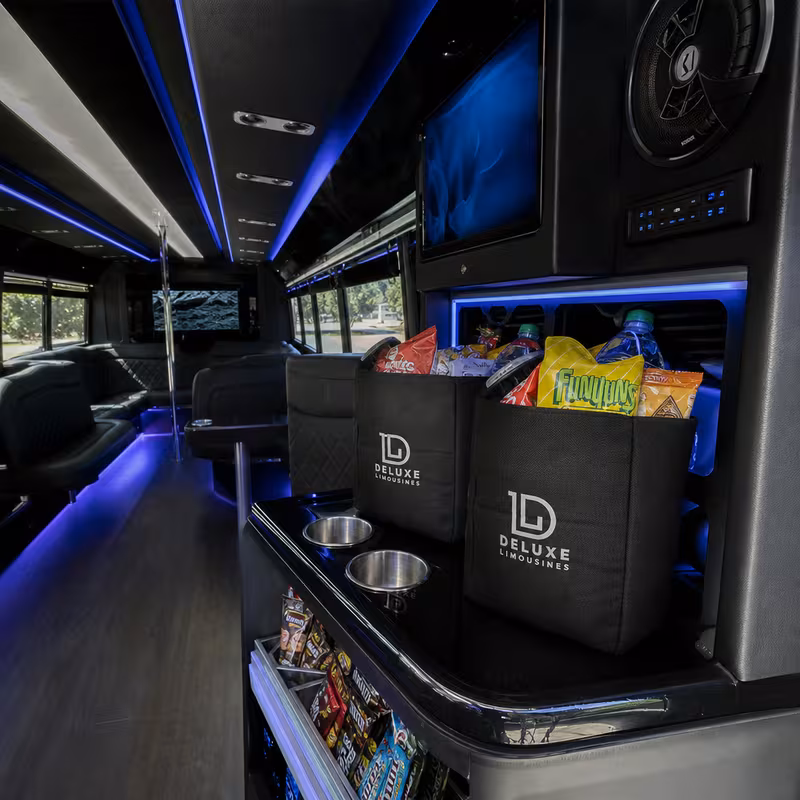 Party bus interior with wraparound leather seating and LED lighting in Wellington